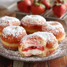 strawberry cream filled doughnuts with powdered sugar on top