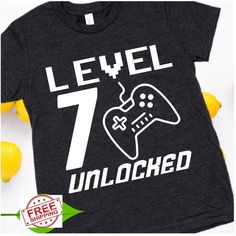 a t - shirt that says level 7 unlocked with a video game controller on it