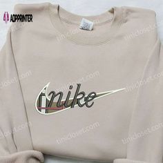 the nike sweatshirt is on display in front of a white background with black and red lettering