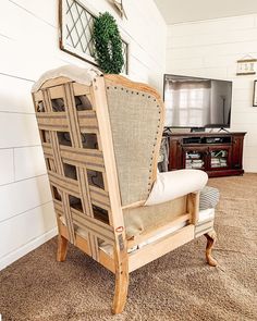 a wooden chair sitting in front of a tv