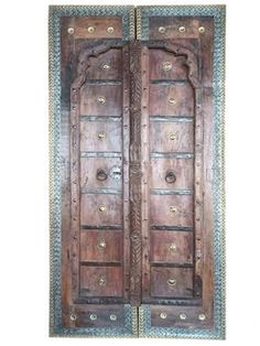 two wooden doors with intricate carvings on them