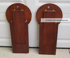 two wooden parking meters sitting in front of a garage door with the word as seen on another sign below them