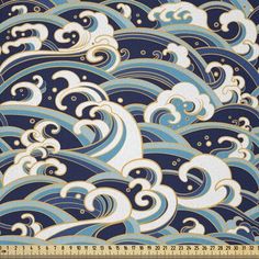 a blue and white pattern with waves on the bottom, in front of a ruler