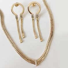 Styling made easy! This discounted set includes our best selling Clear CZ Herringbone Necklace, and our Copa Hoops Necklace is 5mm wide, and 16"-18" long Hoops are 22mm x 60mm and feature clear CZ stone details Choose from heavy 14K Gold over Brass, or Rhodium over Brass. Classic Gold Necklace With Hand Set, Classic Gold Hand Set Necklace, Classic Hand Set Gold Necklace, Classic Hand-set Gold Jewelry Sets, Costume Jewelry Yellow Gold Chain, Classic Gold Jewelry Sets, Yellow Gold Costume Jewelry Chain, Gold Diamond Box Chain Jewelry, Gold Costume Jewelry With Diamond Accents