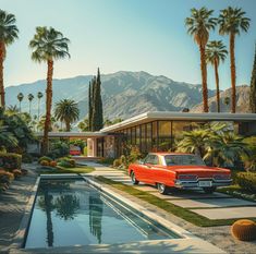 a red car parked in front of a pool surrounded by palm trees and bushes with mountains in the background