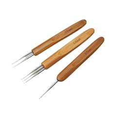 three forks with wooden handles and metal tips