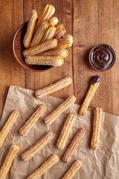 churros and dipping sauce on a wooden table