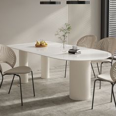 a white table with four chairs around it and a vase on the table next to it