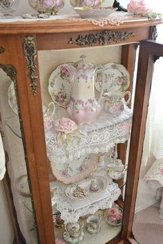 an antique china cabinet with pink roses on it