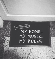 a black and white photo of a sign that says attention my home my music my rules