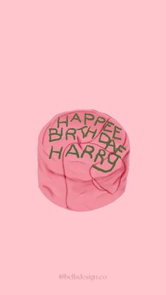 a pink birthday hat with the words happy birthday harry written in black ink on it