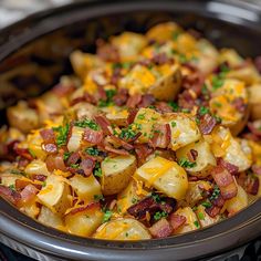 potatoes with bacon and cheese in a crock pot ready to be cooked on the stove