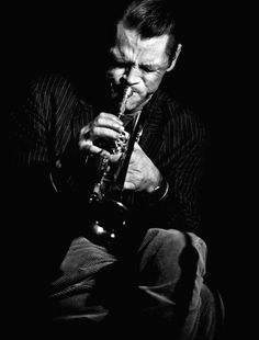 black and white photo of a man playing the saxophone