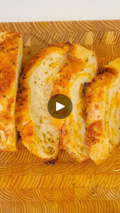 slices of bread sitting on top of a wooden cutting board