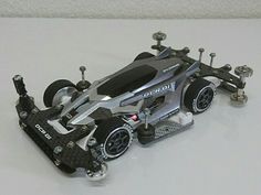 a toy race car is shown on a white surface with no wheels or rims