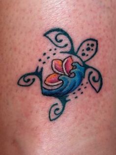 a small tattoo on the side of a woman's leg, with an image of a