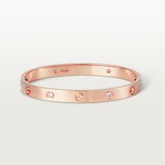 Cartier - LOVE bracelet, 4 diamonds - Bracelet Pink gold/Diamond - LOVE bracelet, 18K rose gold, set with 4 brilliant-cut diamonds totaling 0.42 carats. Sold with a screwdriver. Width: 6.1mm. The iconic #LOVE# bracelet has been a symbol of free-spirited #LOVE# since 1969. Its screw motif and famous locking technology are truly timeless design signatures, while its oval shape ensures a close but comfortable fit to the wearer’s wrist. The locking mechanism consists of two functional screws found o Luxury Bracelet, Bracelet Love, Love Bracelet, Cartier Love, Diamonds And Gold, Gold Plated Bracelets, Bracelet Collection, Cartier Love Bracelet, Love Bracelets