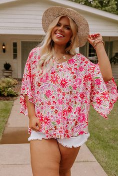 Pink Floral Ruffled Half Sleeve V-neck Plus Size Blouse Casual Pink V-neck Top For Summer, Flowy V-neck Blouse With Floral Print, Chic V-neck Top For Spring Brunch, Feminine V-neck Printed Blouse, Pink Printed V-neck Blouse, Chic Split Neck Top For Vacation, Chic Split Neck Tops For The Beach, Feminine Flowy V-neck Top, Feminine Spring Tops With Split Neck