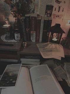 an open book sitting on top of a wooden table next to a lamp and bookshelf