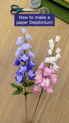 some flowers and scissors on a table with the words how to make a paper delphium