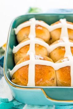 hot cross buns with icing in a blue dish