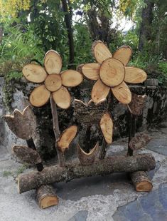 a group of wooden logs with flowers on them