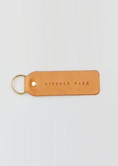 a leather keychain with the words lincoln park engraved on it's side