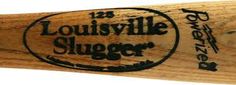 a close up of a baseball bat with the name of the team on it and an engraved logo