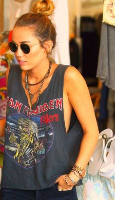 a woman wearing sunglasses and a tank top