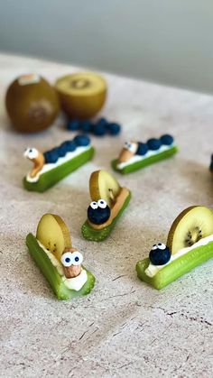 several pieces of fruit are arranged in the shape of people on banana slices with eyes