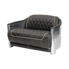 a black and silver couch sitting on top of a white floor