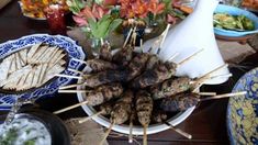 there are many skewers on the table ready to be eaten and served for consumption