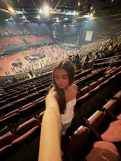 a woman taking a selfie in an empty stadium