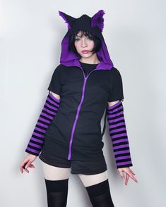 "𝘾𝘼𝙏 𝙀𝘼𝙍𝙎 𝙃𝙊𝙊𝘿𝙄𝙀 - 𝙋𝙐𝙍𝙋𝙇𝙀 - 𝙈𝘼𝙇𝙀 / 𝙁𝙀𝙈𝘼𝙇𝙀 𝘾𝙐𝙏 Black cat hoodie with ears. This cat ear hoodie has purple fur inside the standing cat ears. 𝗪𝗛𝗔𝗧 𝗪𝗜𝗟𝗟 𝗜 𝗥𝗘𝗖𝗘𝗜𝗩𝗘 ♥ Zip up hoodie ♥ Hood with cat ears (fur inside) ♥ Detachable sleeves (easy to apply!) ♥ Sleeves with thumbholes ♥ Big pockets to hold your stuff :D 𝗙𝗔𝗕𝗥𝗜𝗖: Cotton sweatshirt, faux fur for the ears 𝗦𝗜𝗭𝗘: Male or female cut. Size chart you will find it on the last photo! For custom Emo Hooded Winter Hoodie, Emo Cotton Hoodie For Winter, Winter Emo Cotton Hoodie, Casual Purple Hoodie For Halloween, Emo Hooded Cotton Top, Hooded Emo Cotton Top, Emo Style Tops For Cosplay In Winter, Emo Style Tops For Winter Cosplay, Alternative Hooded Hoodie For Cosplay