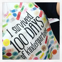 a person holding a large bag that says i survived 100 days of kindergarts