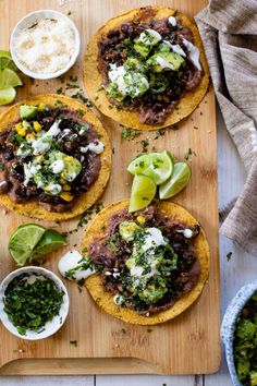 three tortillas topped with black beans, avocado and cilantro