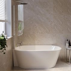 a white bath tub sitting next to a window