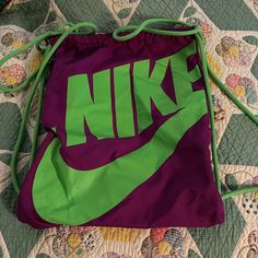 Bright Purple With Neon Green Nike Written. Different Than Most Bags As Zipper On Upper Left That Goes From One Side To Another! Never Used. Non Pet, Non Smoking Household Casual Purple School Bag, Trendy Purple Bag With Dust Bag Included, Sporty Purple Gym Bag For Travel, Casual Purple Pouch Bag, Trendy Green Sports Bags, Purple Pouch Bag For School, Purple Tote Bag For School, Purple Tote School Bag, Nike Pink Bag For Daily Use