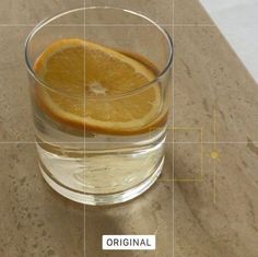 an orange slice in a glass of water on a counter top with the words original below it