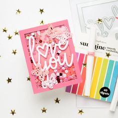 a card with the words i love you on it next to some crafting supplies