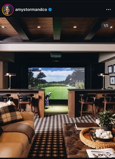 a living room filled with furniture and a flat screen tv mounted to the wall next to a bar