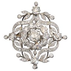 A Belle Époque diamond brooch, set with a cushion shaped old-cut diamond, in the centre, weighing approximately 1.82 carat, in our opinion the colour is I-J, with a surrounding cluster of ten old-cut diamonds, with an approximate total weight of 2.30 carats, in claw settings, bordered by a garland of ribbons, leaves and buds, with single old-cut diamonds, in claw settings, set above, below and either side, with a total weight of approximately 1.60 carat, in grain settings, with millegrain edges, Diamond Flower Brooch, Diamond Cufflink, Diamond Crown, Diamond Brooch, Classy Jewelry, Heart Shaped Diamond, Diamond Drop Earrings, Diamond Bangle, Art Deco Diamond