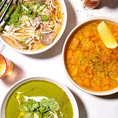 three bowls of soup are sitting on a table