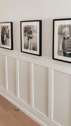 three black and white pictures hanging on the wall next to a wooden floor with hardwood floors