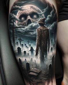 a man's arm with a skull and graveyard scene on it