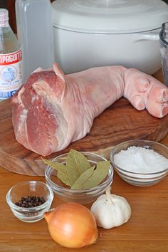 raw meat and spices on a wooden cutting board