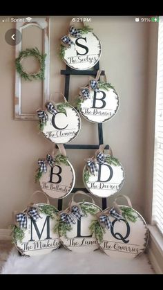 a christmas tree made out of plates with monogrammed letters and wreaths on them