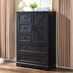 an armoire with doors and drawers is shown in front of a beige curtained window