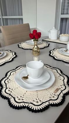 the table is set with white and black placemats