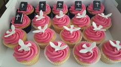 cupcakes decorated with pink frosting and white crosses